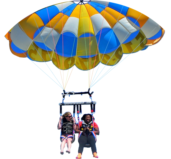 Regina Blye and Christina Cernasky parasailing over Travis Lake near Austin